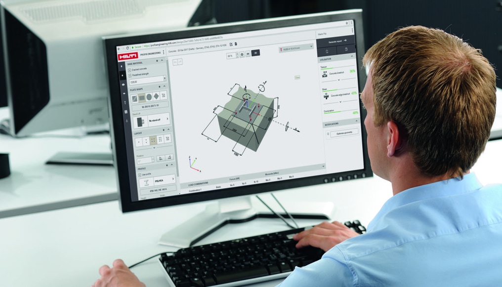 Man working on pc, using construction design software.