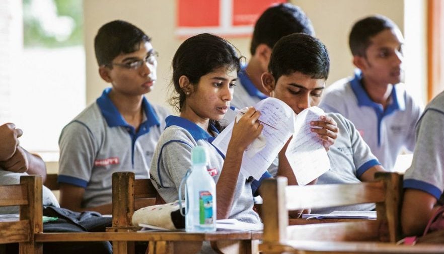 School kids sitting in classroom.